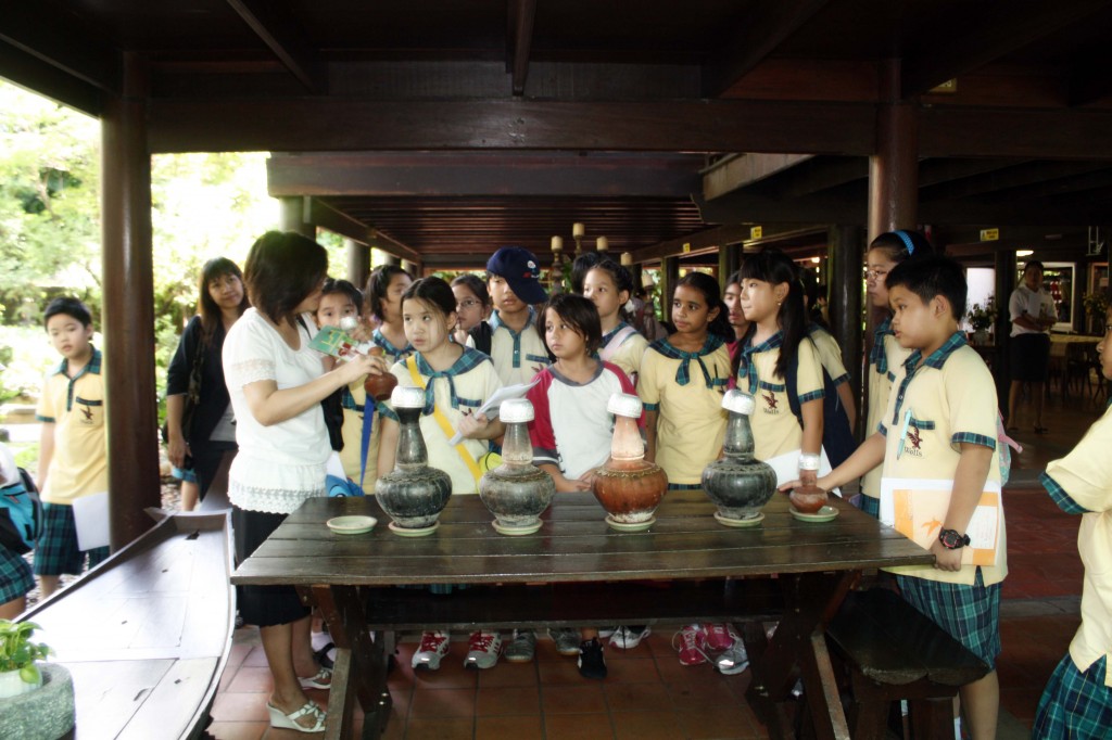 Ms. Jim, our Thai principal, explains how water was stored in the past. The clay pots acted as insulators, keeping water cool.