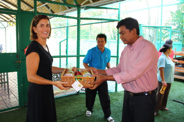 Manager of support staff receives fruit basket on behalf of his personnel