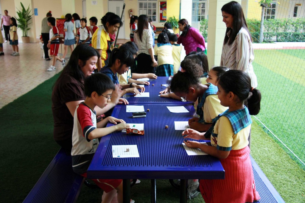 Teachers, office staff and students play a “Dice Game,” organized by Grade 1 students