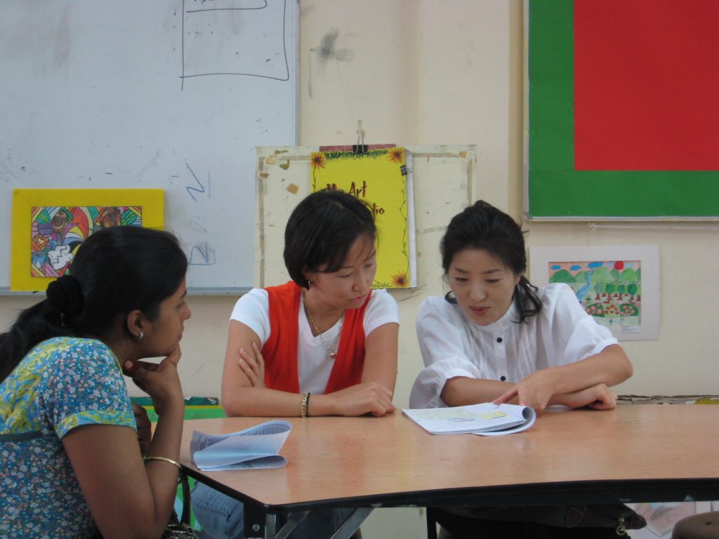 Parents of Grade 2 students examining and discussing about student work 