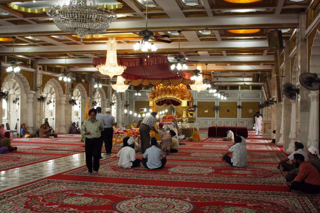 Worshipers listen to the reading of the Guru Granth Sahib.