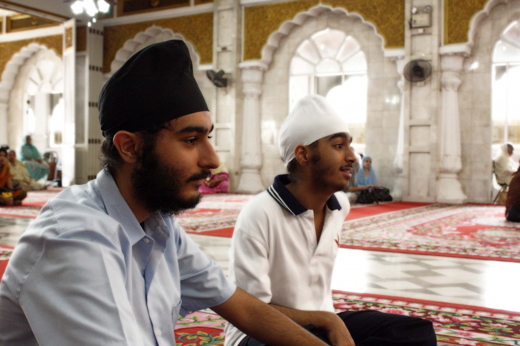 Nick and Visant listen to the reading of the Guru Granth Sahib.