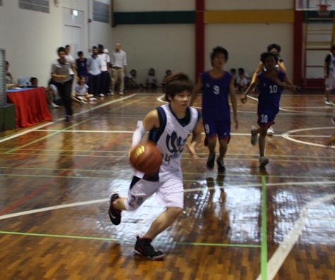 Freshman guard Jim outruns Prep defenders going for an easy layup.