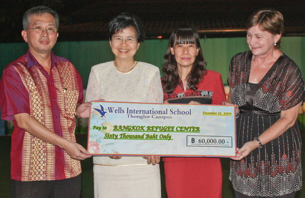 From left: Presentation of check by Mr. Chang Yao-Lang, Chairman, Wells International School to Khun Aumphornpun Buavirat, Program Manager; Khun Charatkorn Mankhatitham, Operation Manager; Ms. Dorothy Laughton, Australian Volunteer -Staff and Curriculum Development from the Bangkok Refugee Center (BRC). 