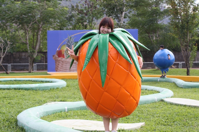 Donning a pineapple outfit, 8th-grader Marin races across the winding path.